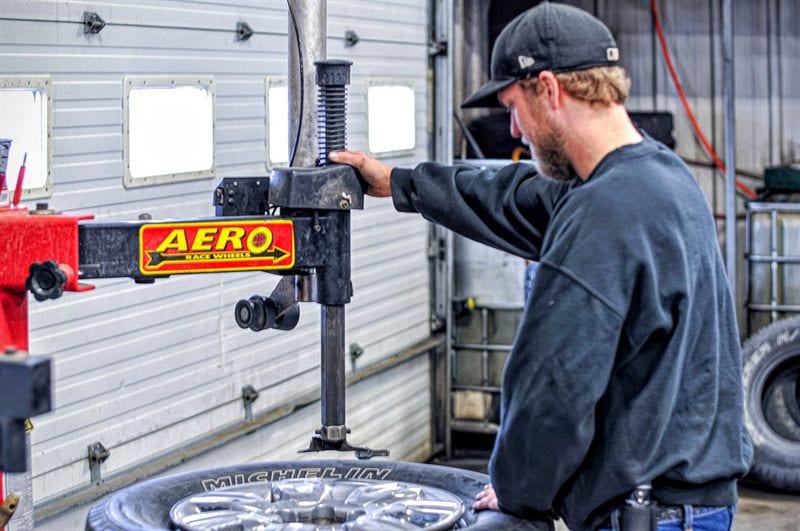 Technician mounting a new tire during tire service at Corey's Car Care Center in Fargo, ND